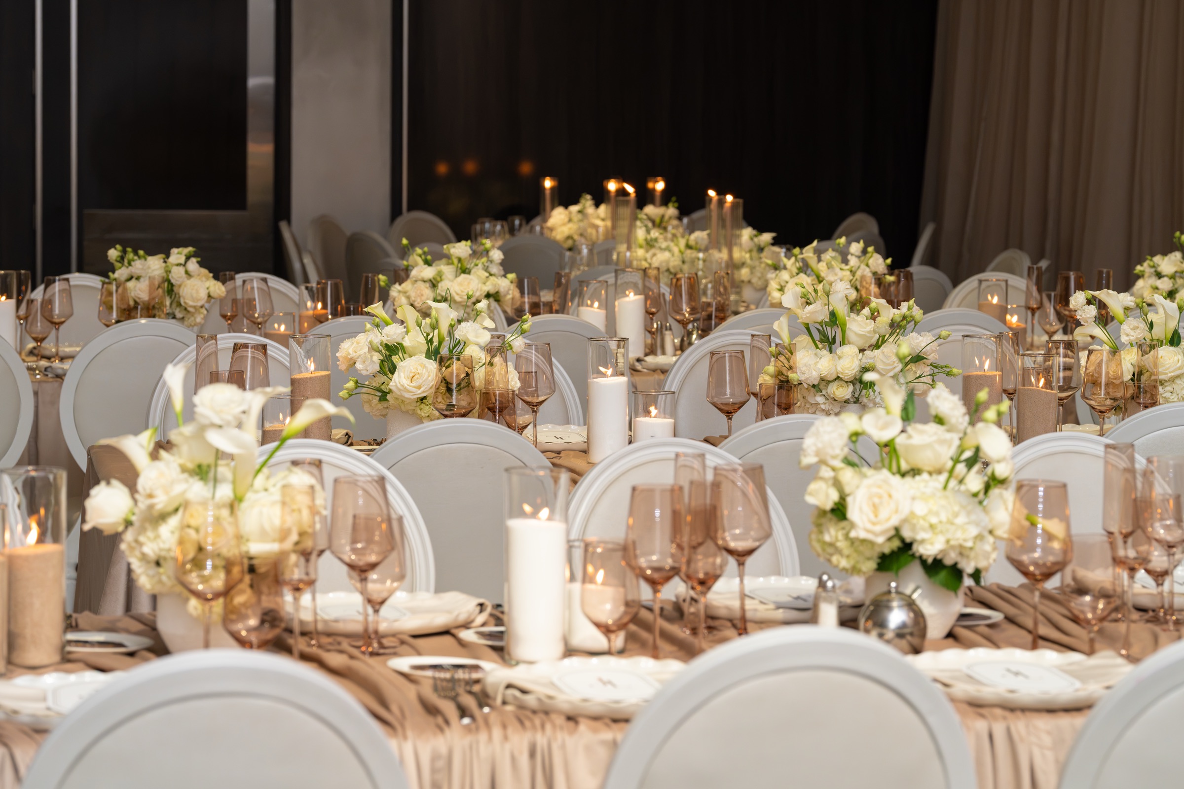 The Château Le Parc ballroom set for dinner with candles and white florals